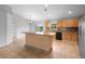 Open-concept kitchen with granite counters, stainless appliances, and center island for entertaining at 1576 Naples Cir, Deltona, FL 32738