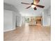 Open-concept living area with tile flooring, a ceiling fan, and a clear view into the kitchen at 1576 Naples Cir, Deltona, FL 32738