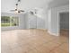 Bright living room with tile flooring and a view of the front door and neighboring outdoor spaces at 1576 Naples Cir, Deltona, FL 32738