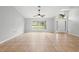 Open living space with tile flooring, a large window, ceiling fan, and decorated front door at 1576 Naples Cir, Deltona, FL 32738