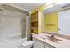 Well-maintained bathroom with a bathtub and shower combination, cabinet, and a marble-style countertop at 1 Oceans West Blvd # 1B2, Daytona Beach, FL 32118