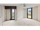 Bright bedroom featuring neutral carpet, a ceiling fan, and sliding glass doors to balcony with exterior views at 1 Oceans West Blvd # 1B2, Daytona Beach, FL 32118