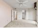 Carpeted bedroom featuring a ceiling fan, closet, and entryways to the bathroom and walk-in closet at 1 Oceans West Blvd # 1B2, Daytona Beach, FL 32118