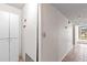 Hallway with tile floors, storage cabinet, and exterior views through sliding glass door at 1 Oceans West Blvd # 1B2, Daytona Beach, FL 32118
