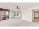Cozy living room featuring a ceiling fan and sliding glass doors that open to a balcony at 1 Oceans West Blvd # 1B2, Daytona Beach, FL 32118