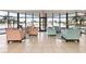 Relaxing lobby area with comfortable seating, tiled floors, and large windows overlooking the pool area at 1 Oceans West Blvd # 1B2, Daytona Beach, FL 32118