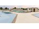 Community pool area with lounge chairs and a building providing shade at 1 Oceans West Blvd # 1B2, Daytona Beach, FL 32118