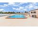 Community pool with tiled edge, lounge seating, and a shade providing building at 1 Oceans West Blvd # 1B2, Daytona Beach, FL 32118