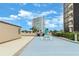 Rooftop amenity area with a grill and seating, and a view of another high rise building at 1 Oceans West Blvd # 1B2, Daytona Beach, FL 32118