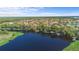 Beautiful aerial view of a lakefront community surrounded by lush trees, natural beauty, and private boat docks at 100 Via Rosa Ct, Debary, FL 32713