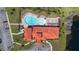 Stunning aerial view of the community pool and clubhouse with ample parking and lush landscaping at 100 Via Rosa Ct, Debary, FL 32713
