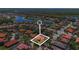 Aerial view of a residential area with houses, tree coverage, and ponds at 100 Via Rosa Ct, Debary, FL 32713