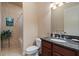 This bathroom has tile flooring, a sink with granite countertop, toilet, and tub with shower at 100 Via Rosa Ct, Debary, FL 32713