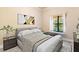 Bedroom with neutral walls and wood floors; window brings in lots of natural light at 100 Via Rosa Ct, Debary, FL 32713