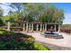 Picturesque courtyard with a fountain, pergola and lush greenery, perfect for outdoor relaxation and gatherings at 100 Via Rosa Ct, Debary, FL 32713