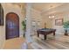 Spacious game room featuring a pool table, wood floors, and large windows for natural light at 100 Via Rosa Ct, Debary, FL 32713