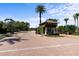 Secure gated community entrance with lush landscaping, offering privacy and peace of mind for residents at 100 Via Rosa Ct, Debary, FL 32713