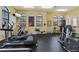 Well-equipped gym with treadmills, elliptical machines, and weight training equipment for a complete workout at 100 Via Rosa Ct, Debary, FL 32713