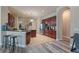 Kitchen featuring an island, stainless steel appliances, tile floors, wood cabinets, and breakfast bar at 100 Via Rosa Ct, Debary, FL 32713