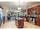 Spacious kitchen with an island, stainless steel appliances, tile floors, and wooden cabinets at 100 Via Rosa Ct, Debary, FL 32713