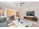Bright living room featuring modern furniture and a view to the kitchen at 100 Via Rosa Ct, Debary, FL 32713