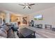Spacious living room with a leather sofa, open to the kitchen and dining area at 100 Via Rosa Ct, Debary, FL 32713