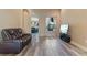 Cozy living room with a leather recliner, media center, and a view to the kitchen at 100 Via Rosa Ct, Debary, FL 32713