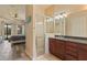 Main bathroom featuring a shower, dark wood cabinet, and view of main bedroom at 100 Via Rosa Ct, Debary, FL 32713