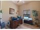 This office features hardwood floors, a window with natural light, a desk, and a chair at 100 Via Rosa Ct, Debary, FL 32713