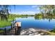 Scenic waterfront view of the lake featuring a private dock and tranquil surroundings at 100 Via Rosa Ct, Debary, FL 32713