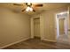 Bedroom with wood-look flooring, closet and ceiling fan at 1013 Matterhorn St, Deltona, FL 32725