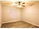 Bedroom with wood-look flooring, ceiling fan, and neutral walls at 1013 Matterhorn St, Deltona, FL 32725