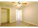 Bedroom with ceiling fan, closet, and light gray vinyl flooring at 1013 Matterhorn St, Deltona, FL 32725