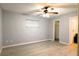 Bedroom with light wood floors, a ceiling fan, window, closet, and ensuite bathroom entry at 1013 Matterhorn St, Deltona, FL 32725