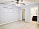 Spacious bedroom with light wood floors, a ceiling fan, window, closet, and ensuite bath access at 1013 Matterhorn St, Deltona, FL 32725