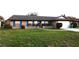 Single-story brick home with a well-manicured lawn, blue shutters, and an attached two-car garage at 1013 Matterhorn St, Deltona, FL 32725
