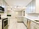 Modern kitchen with quartz countertops, stainless steel appliances, and open layout at 1013 Matterhorn St, Deltona, FL 32725
