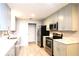 Well-lit kitchen with gray cabinets and stainless steel appliances at 1013 Matterhorn St, Deltona, FL 32725