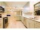 Well-lit kitchen with gray cabinets and stainless steel appliances and open floor plan at 1013 Matterhorn St, Deltona, FL 32725