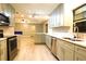 Modern kitchen featuring stainless steel appliances, granite countertops, and stylish light green cabinetry at 1013 Matterhorn St, Deltona, FL 32725