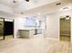 Open-concept living area with wood-look flooring, connected to a modern kitchen and access to the patio at 1013 Matterhorn St, Deltona, FL 32725