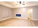 Bright living room with tray ceiling, wood-look floors, and modern fireplace at 1013 Matterhorn St, Deltona, FL 32725