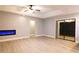Open living room with sliding glass doors and modern fireplace at 1013 Matterhorn St, Deltona, FL 32725