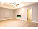 Bright living room with tray ceiling, wood-look floors, and modern fireplace at 1013 Matterhorn St, Deltona, FL 32725