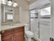Bathroom featuring granite vanity and a glass-enclosed shower with decorative tile accents at 1033 Windbrook Dr, Deltona, FL 32725