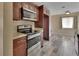 Updated kitchen with stainless steel appliances and stylish wood-look tile flooring at 1033 Windbrook Dr, Deltona, FL 32725