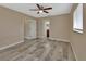 Spacious main bedroom with stylish wood-look tile flooring, and neutral colored walls at 1033 Windbrook Dr, Deltona, FL 32725