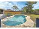 Backyard view showcasing a sparkling in-ground pool, offering a refreshing retreat with ample space for relaxation and recreation at 1033 Windbrook Dr, Deltona, FL 32725