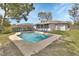 Backyard view featuring a refreshing in-ground pool, deck, and landscaped yard, ideal for outdoor relaxation and entertainment at 1033 Windbrook Dr, Deltona, FL 32725