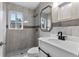 Bathroom featuring neutral tile, a shower, white vanity with a black faucet, and a mirror at 1135 Holly Ave, Daytona Beach, FL 32117